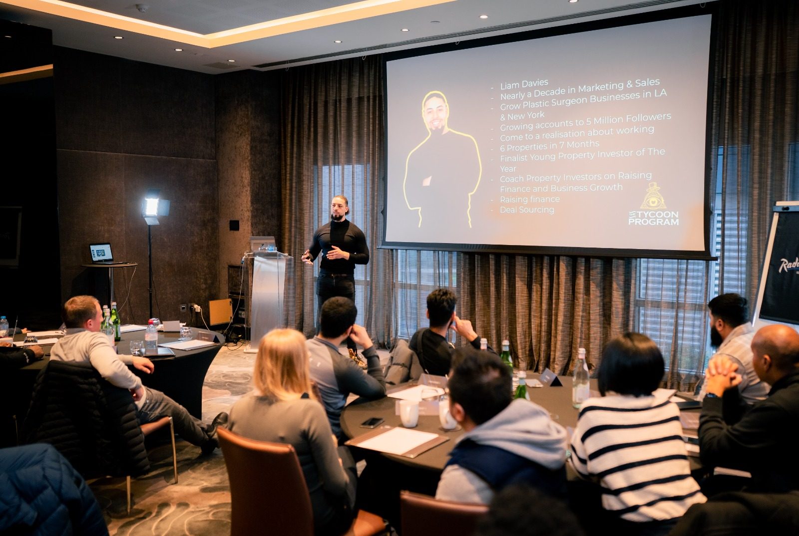 Liam Davies teaching a room of business owners